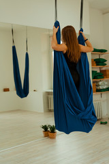 Stretching workout. Healthy lifestyle. Young beautiful girl in black uniform is doing stretching exercise. Akroyoga, yoga, fitness, workout, sport.