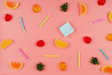 Flat lay view at sweet background of different type candies on pink