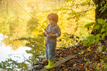 The child is fishing. Meditation in nature. Fishing lake.