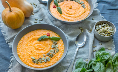 Hot cream soup of pumpkin and carrots on the kitchen table