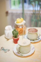 Afternoon tea with cup of hot chocolate on the background. soft focus on the glass drinking straw for eco-friendly concept.