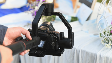 The photographer Video camera operator on stabilizers working with his equipment to pay close...
