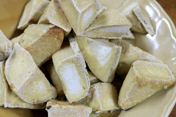 Home made of snack and dessert, Chinese Traditional Deep Fried Tofu or Fried Bean Curd Served in dish on wooden table.