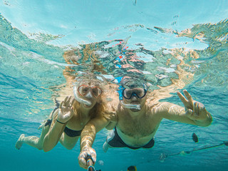 Young couple snorkeling selfie underwater camera on the coral reef in ocean of Egypt Hurghada travel concept vacation - obrazy, fototapety, plakaty