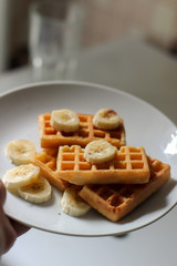 Belgian waffles with banana  on a white plate