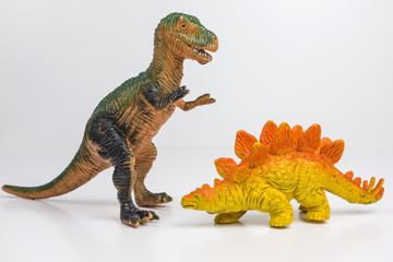 plastic toy figures of tyrannosaurus rex and stegosaur - 316570794