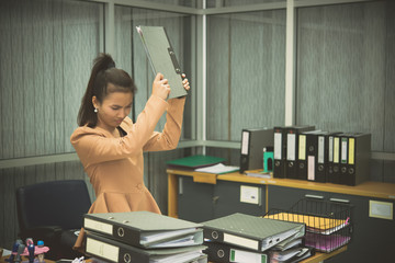 Fototapeta na wymiar Asian woman working in office,young business woman stressed from work overload with a lot file on the desk