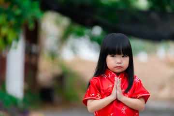 Portrait beautiful asian little girl in Cheongsam dress,Thailand people,Happy Chinese new year concept,Happy Little asian girl in chinese traditional dress