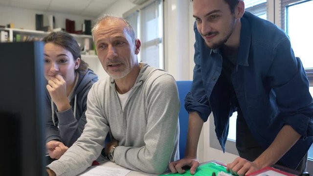 Young people in design office with instructor