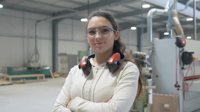 Portrait of woodwork apprentice standing in carpenter shop