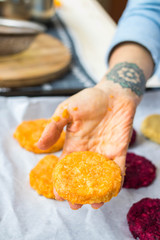 Vegan chickpea burgers cutlets or patties. Healthy vegan diet food. Adult and child hands hold vegan burger's cutlets.