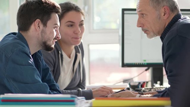 Young people in design office with instructor