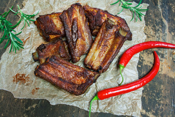 Spicy ribs surrounded by herbs and chili peppers
