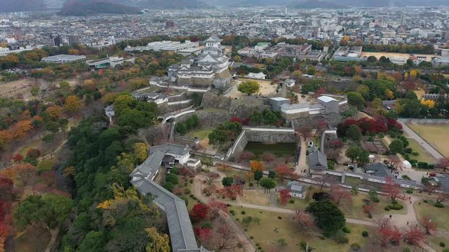 Aerial view of famous Himaji Castle, picturesque autumn scenery with medieval fortress complex and trees of many colors - landscape panorama of Japan from above, Asia