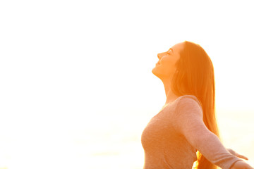 Profile of a woman breathing fresh air on white