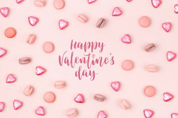 Pattern made of macaroons  and candys on pale pink background.  Sweet concept.  Flat lay, top view