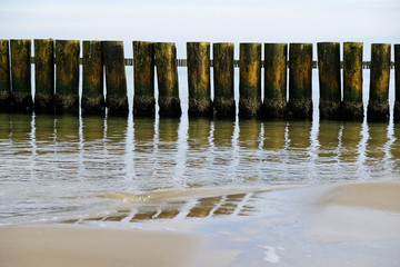 Breakwaters on the beach in Dziwnowek / Poland on the Baltic Sea.