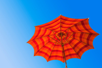 Colorful umbrella white blue sky background