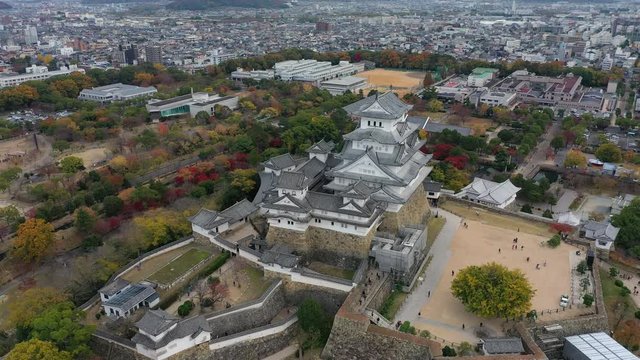 Aerial view of famous Himaji Castle, picturesque autumn scenery with medieval fortress complex and trees of many colors - landscape panorama of Japan from above, Asia