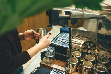 Barista prepares morning delicious coffee using a coffee machine. The process of making coffee