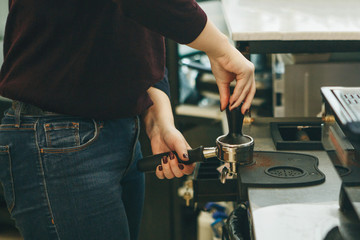 Obraz na płótnie Canvas Making coffee in a cafe. Barista in the process