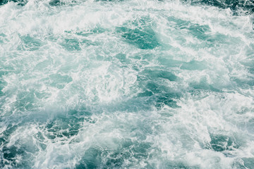 Fototapeta na wymiar Sea foam background. Clear blue sea water with foam