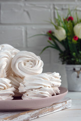 Handmade apple white homemade marshmallows on a pink plate. White background.