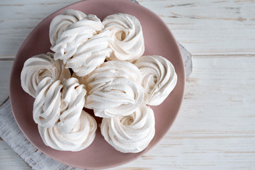Handmade apple white homemade marshmallows on a pink plate. White background.