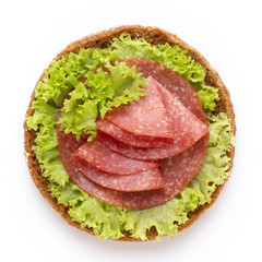 Sandwich with salami sausage on white background.