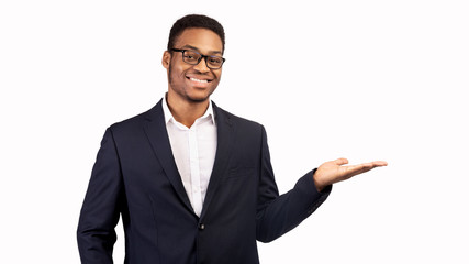 Smiling man with his palm up on white background
