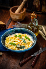 Seafood pasta with shrimp and Basil in cream sauce on a plate on a wooden background