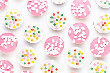Colorful cupcakes on a white background.