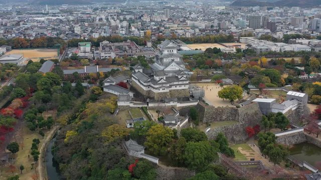 Aerial view of famous Himaji Castle, picturesque autumn scenery with medieval fortress complex and trees of many colors - landscape panorama of Japan from above, Asia