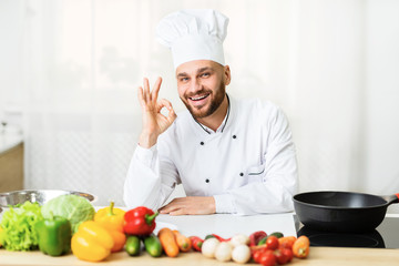 Happy Chef Man Gesturing OK Posing In Kitchen