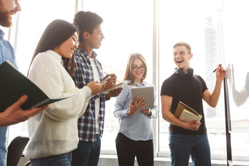 High school pupils discussing math equations in class