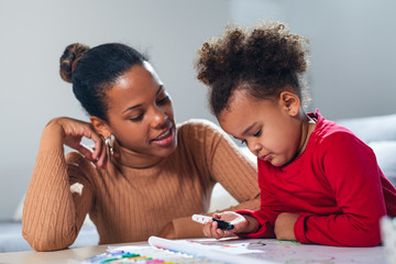 Happy family. Mother and daughter together paint.