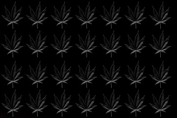 monochrome pattern of black cannabis leaves on a black background