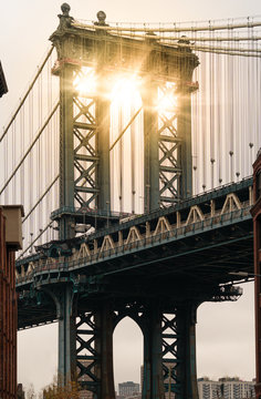 Sun beams through a pillar of Manhattan Bridge as seen from Washington Street in Dumbo district,Brooklyn. New York City.