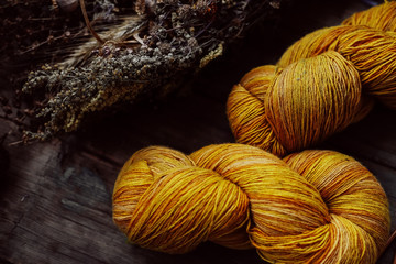 Bright yellow wool yarn skeins in rustic background