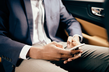 Close up of a man in car using his phone.