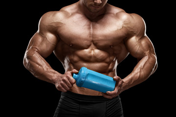 Naklejka premium Muscular man with shaker isolated on black. Strong male naked torso abs