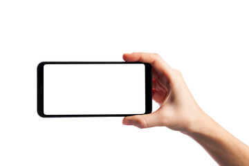 Woman holding smartphone with empty screen isolated on white background. Female hand with phone,...