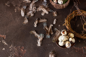 Alternative Easter background with small nest and quail on dark brown stone background.  Eco friendly Easter, zero waste.