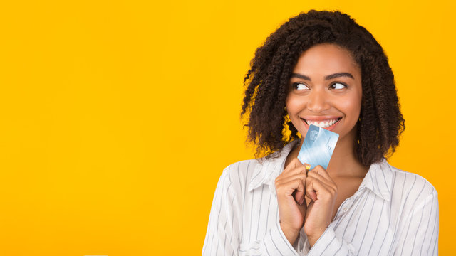Black girl holding credit card thinking about market
