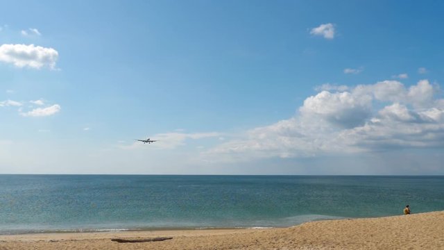 Widebody airplane approaching over ocean