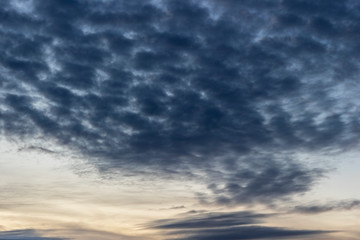 Naklejka na ściany i meble Dark cumulus clouds in the sky after sunset.