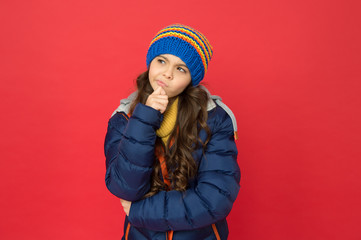 Winter dreaming. thoughtful child in warm winter clothes. seasonal fashion for kids. small beauty...