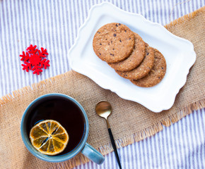 Christmas tea time with oat cookies. Winter tea with slice of orange.