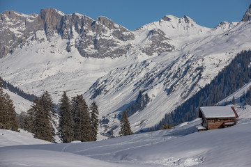Fototapeta na wymiar Mountain huts in a snowy landscape in the swiss Alps, Switzerland, Europe