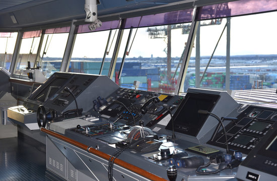 View of the control console on the navigational bridge of the cargo ship. Ship berthed in the port of Newark. 